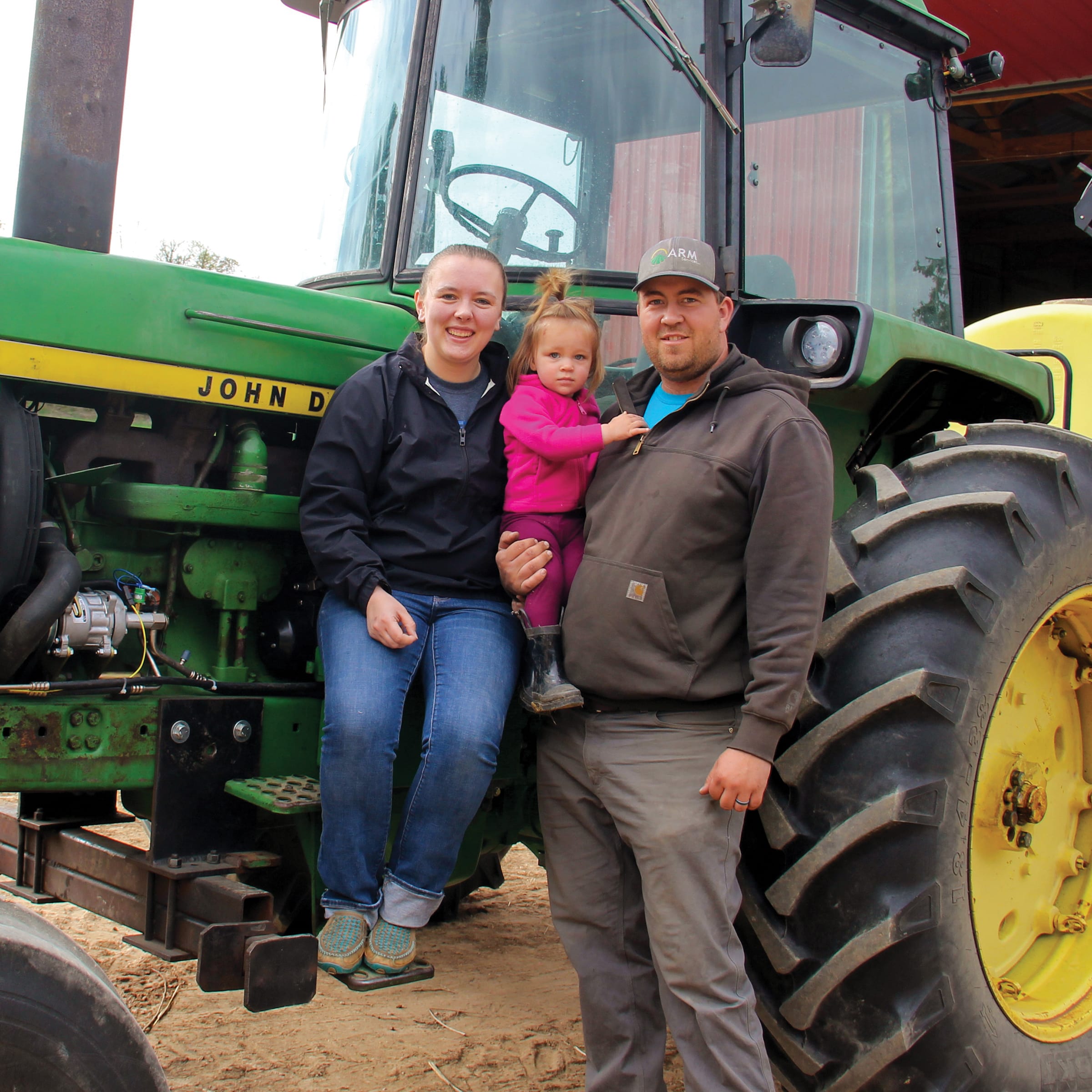 Amber-Evelynn-and-Logan-Dwyer-on-tractor