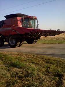 side view of combine on the road