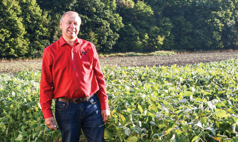 Jim Holte standing in soybean field.