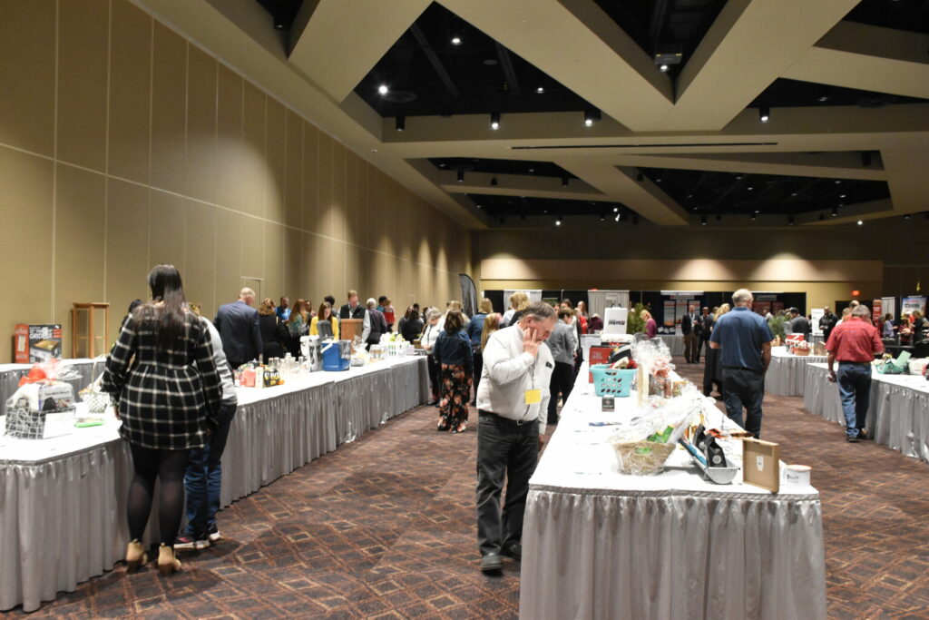 Wisconsin Farm Bureau members view many tables of silent auction items at the WFBF Annual Meeting and YFA Conference.