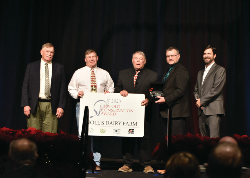 The Noll family receiving the Leopold Conservation Award on stage at the WFBF Annual Meeting.